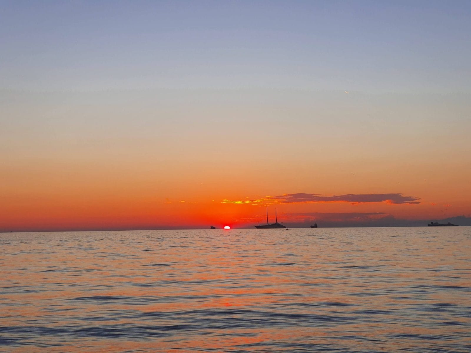 Sun and Boats on Horizon