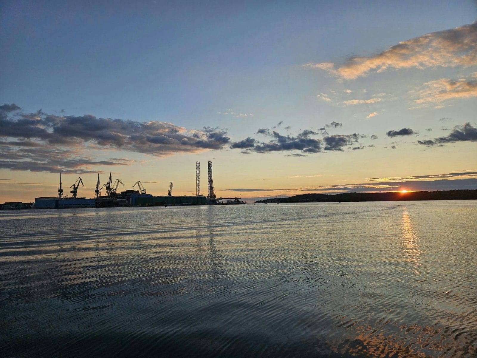 Port cranes in Pula at dusk