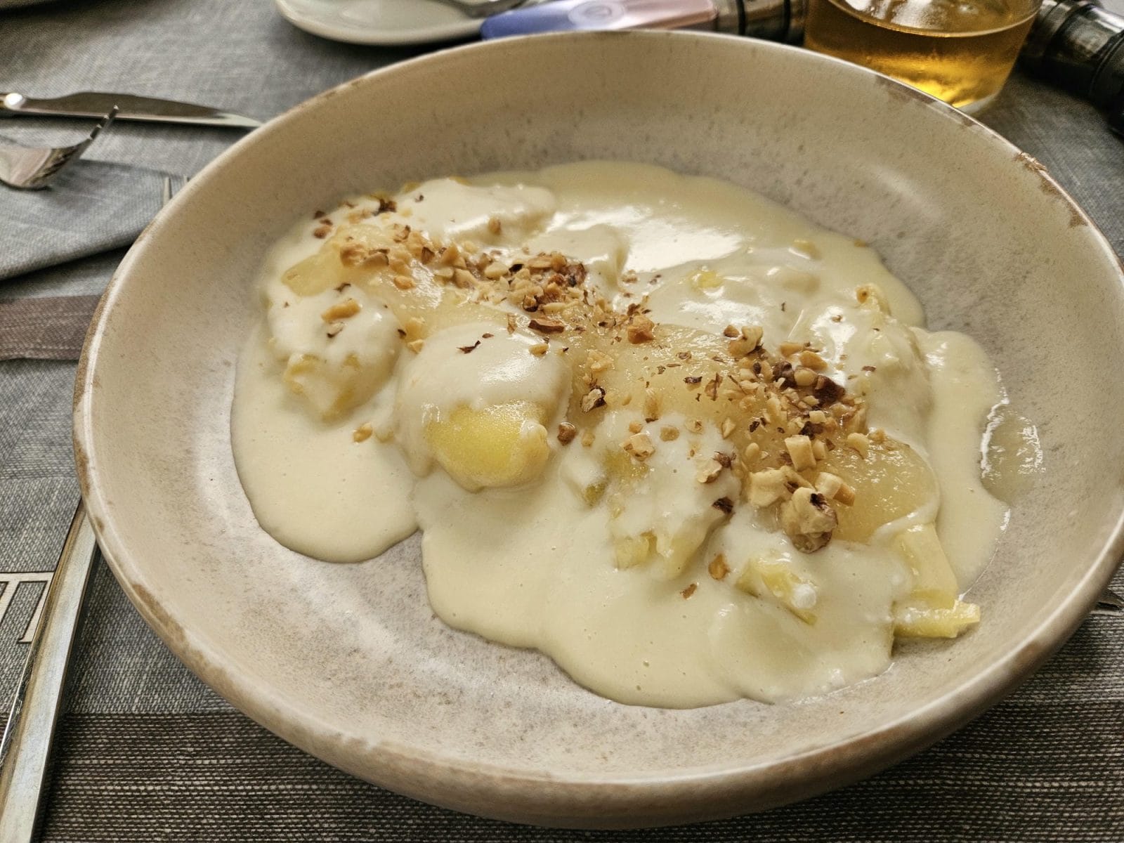 ricotta-filled ravioli with pecorino cheese fondue and pears